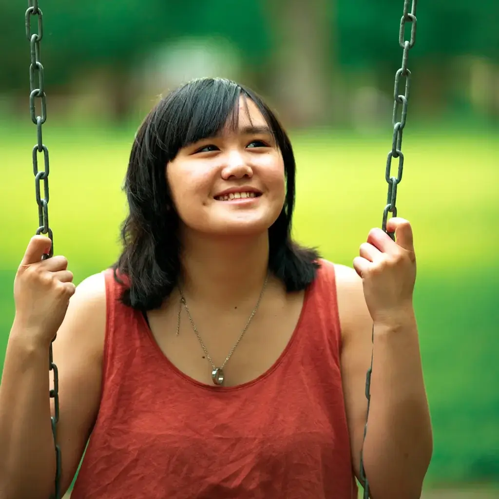 Teen girl on a swingset