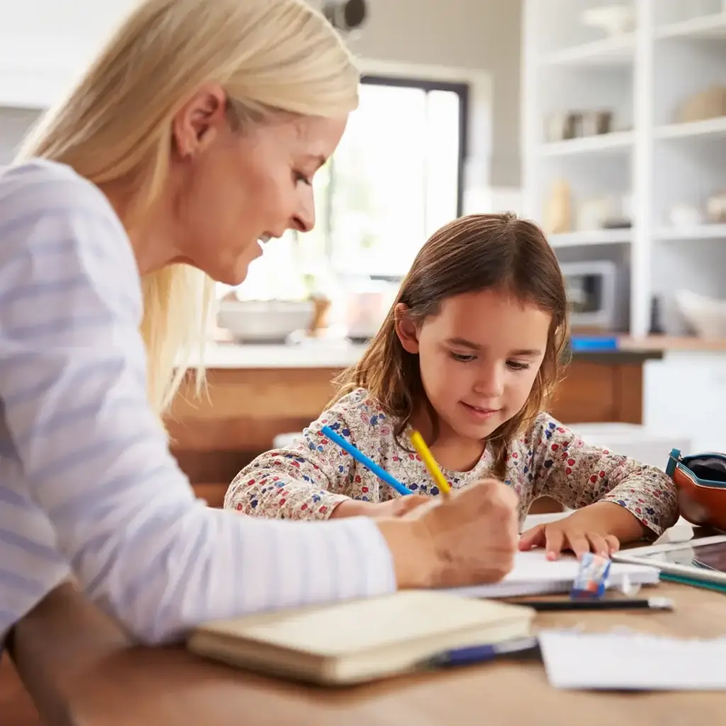 Woman helping child with school work