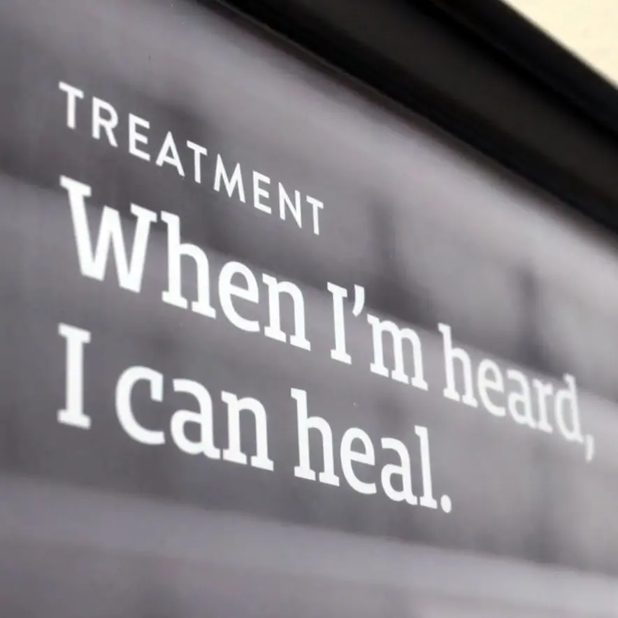 Close up of a sign that says "Treatment: When I'm heard, I can heal."