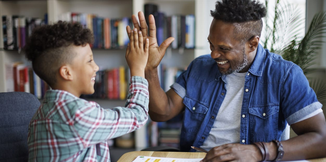 Man helping boy with homework